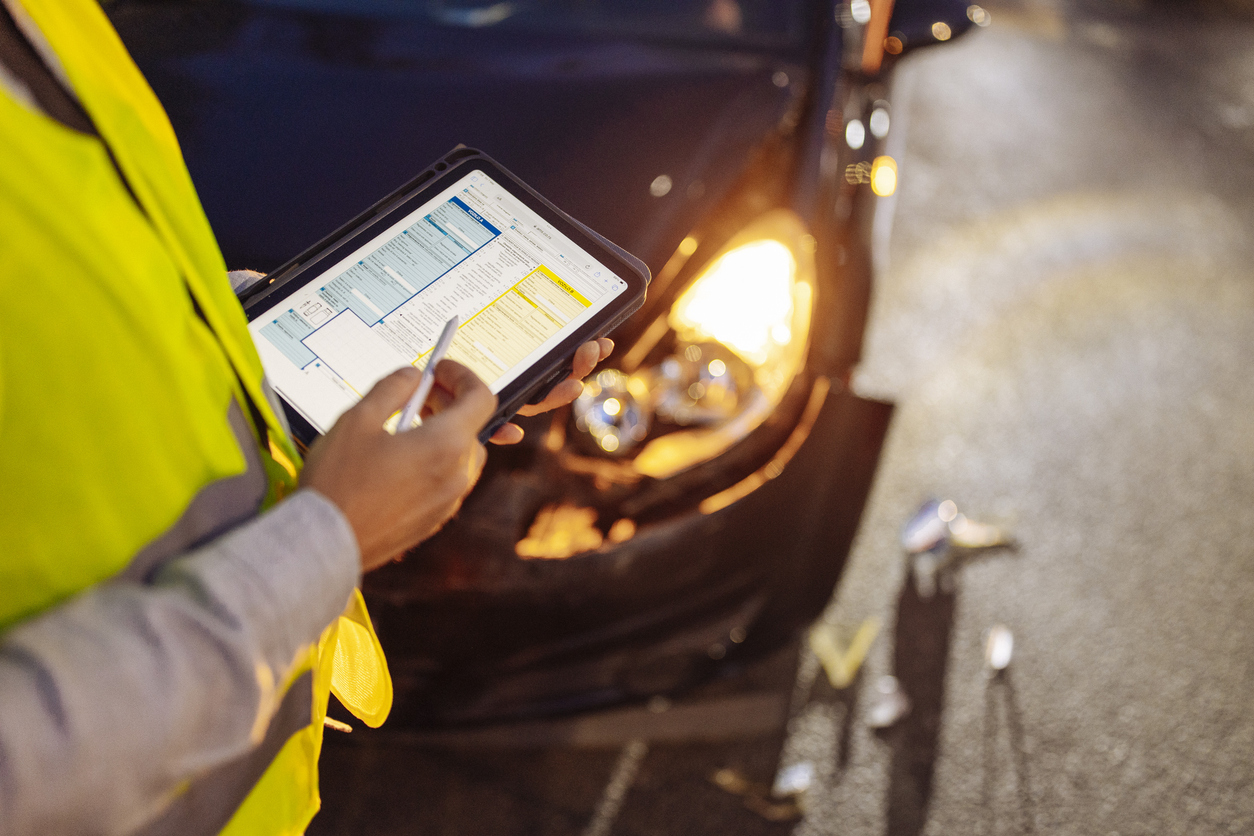 Accident reconstruction expert analyzing truck crash scene