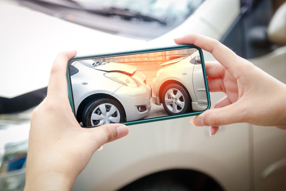 Man taking photos after car accident