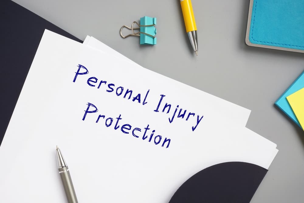 Personal Injury Protection with phrase on the piece of paper. 