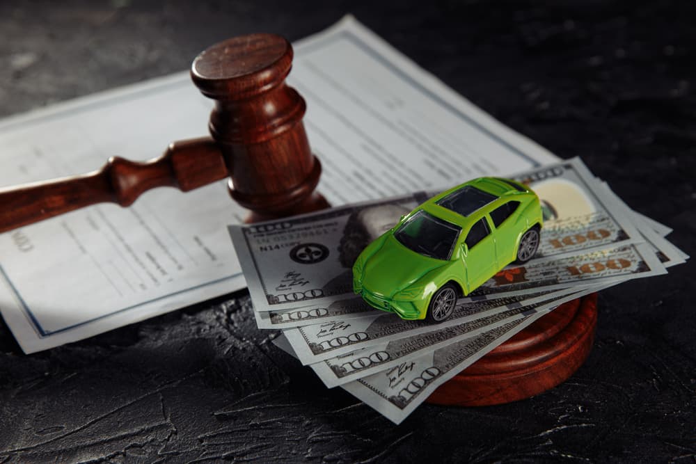 Judge Gavel, money and toy car on a table