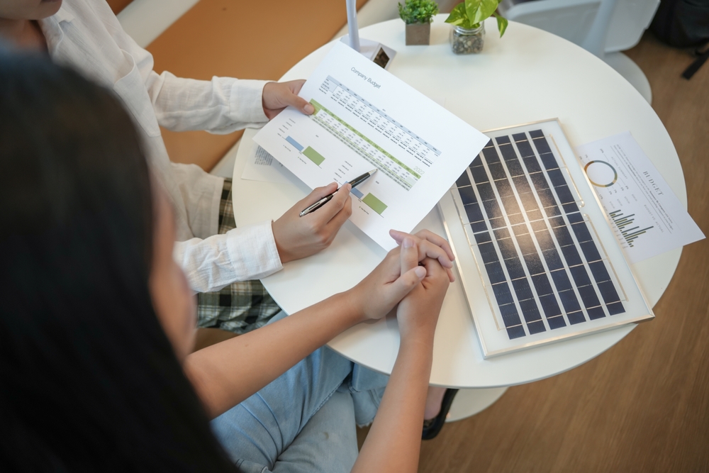 Solar panels green energy Business people working in green eco friendly office business meeting