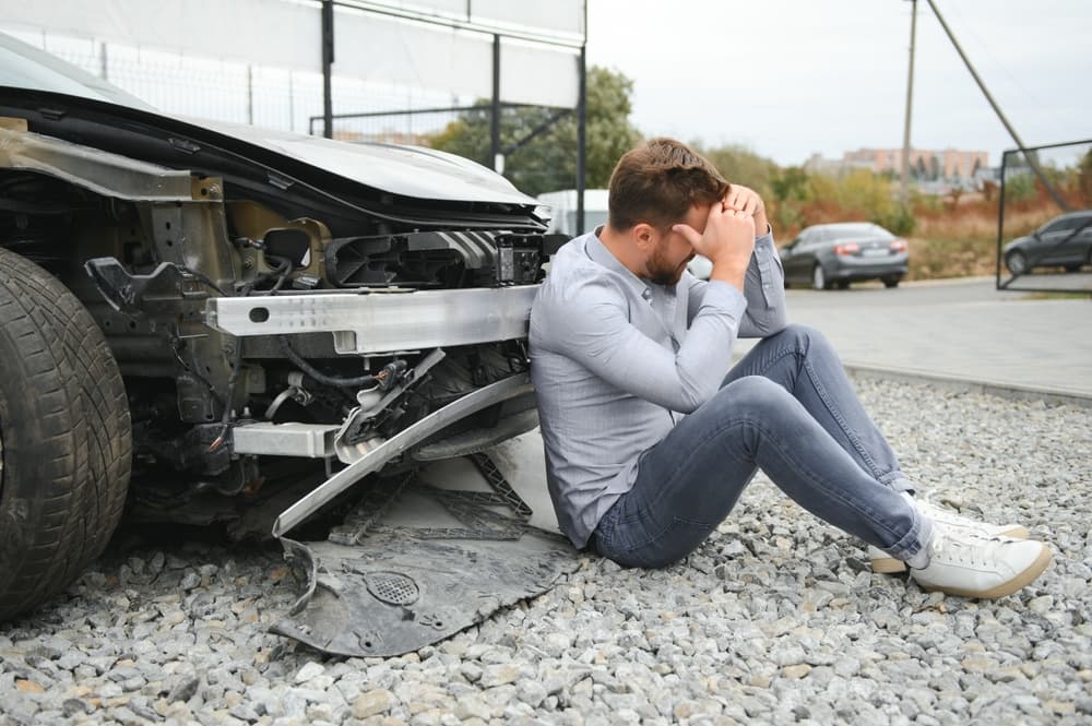 Man feeling headache caused during car wreck.